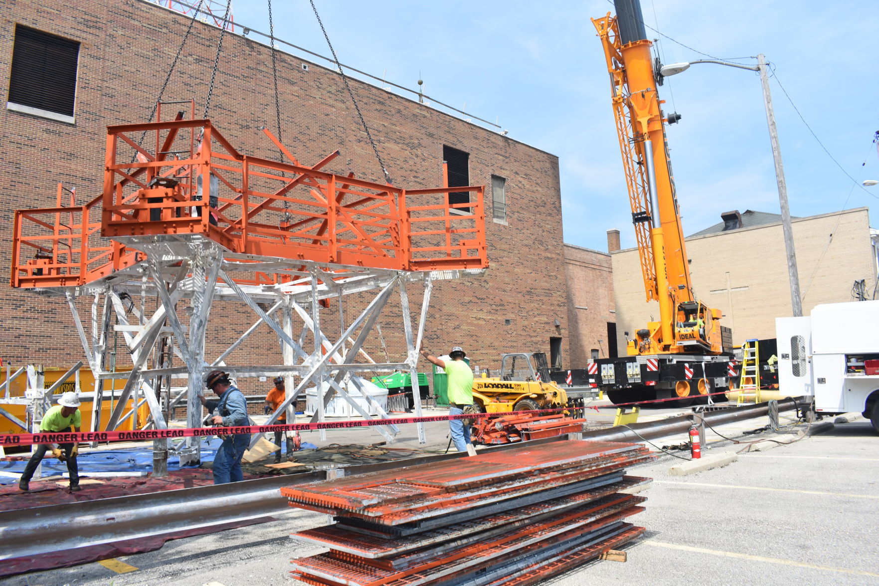 A towering job: Crews dismantle phone tower